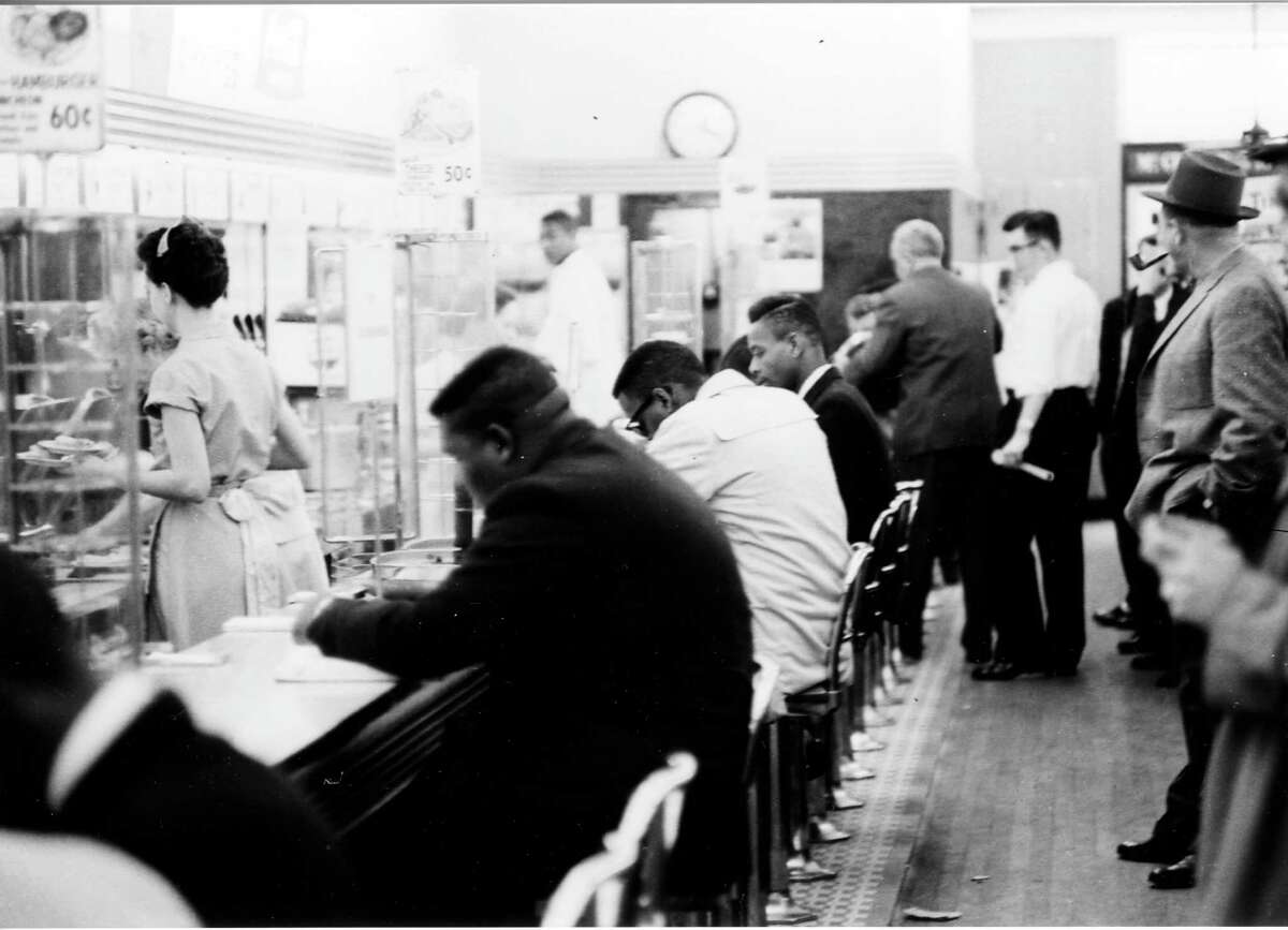 FILE - In this February 1960 file photo, people take part in a civil rights "sit-in" protest at the lunch counter in McCrory's in Rock Hill, S.C. A prosecutor on Wednesday, Jan. 28, 2015, will argue a motion to vacate the convictions of a group known as the Friendship Nine. Eight Friendship Junior College students and a civil rights organizer were convicted of trespassing and breach of peace for staging a similar protest at the same lunch counter in 1961. The men opted for a monthâs hard labor rather than allow bail to be posted for them by civil rights groups. (AP Photo/The Herald, File)