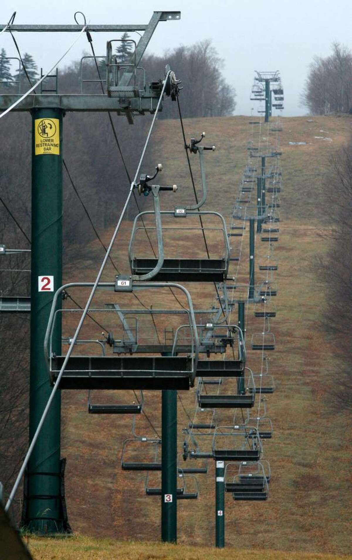 Ski lifts are silent and the slopes are bare at the Sugarbush ski resort in Warren, Vt., Friday, Nov. 27, 2009. Many Vermont ski areas have been closed for the Thanksgiving holiday. Weather forecasters say a strong nor'easter storm is heading through New England on Friday, with the possibility of leaving behind some high-elevation snow for Vermont's ski slopes.(AP Photo/Toby Talbot)