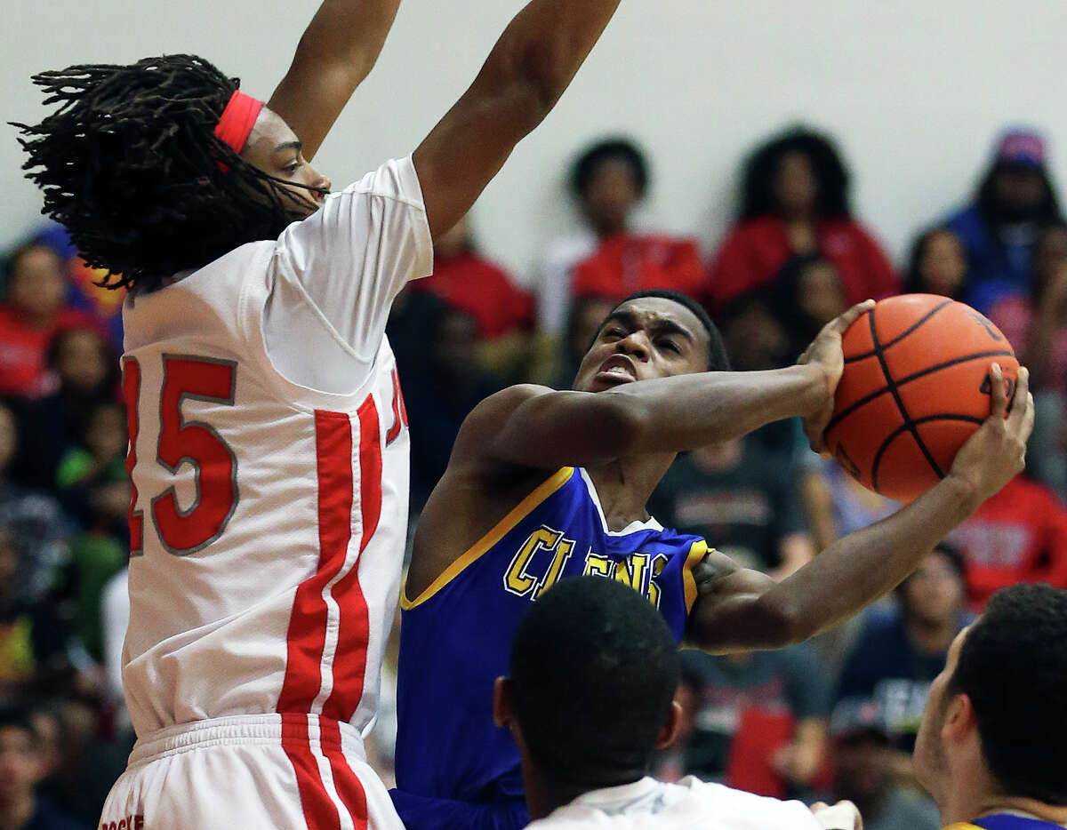Clemens guard Jalon Gates double pumps a shot under the basket against Judson’s Brandon Armstrong in a 26-5A game at Judson High School Tuesday. Clemens used a fourth quarter comeback to beat the Rockets 73-68.