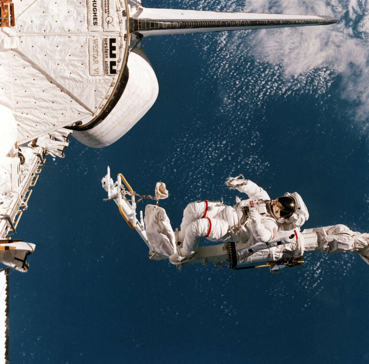 In this photo provided by NASA, Mission specialist Bruce McCandless is shown outside of the Space Shuttle Challenger, Feb. 7, 1984, using a remote manipulator system (RMS) arm and mobile foot restraint (MFR) to experiment with a "cherry picker" concept. The photograph of McCandless ranks among NASAs top five or six most-requested images. See a collection of tweets from another legendary NASA pioneer.