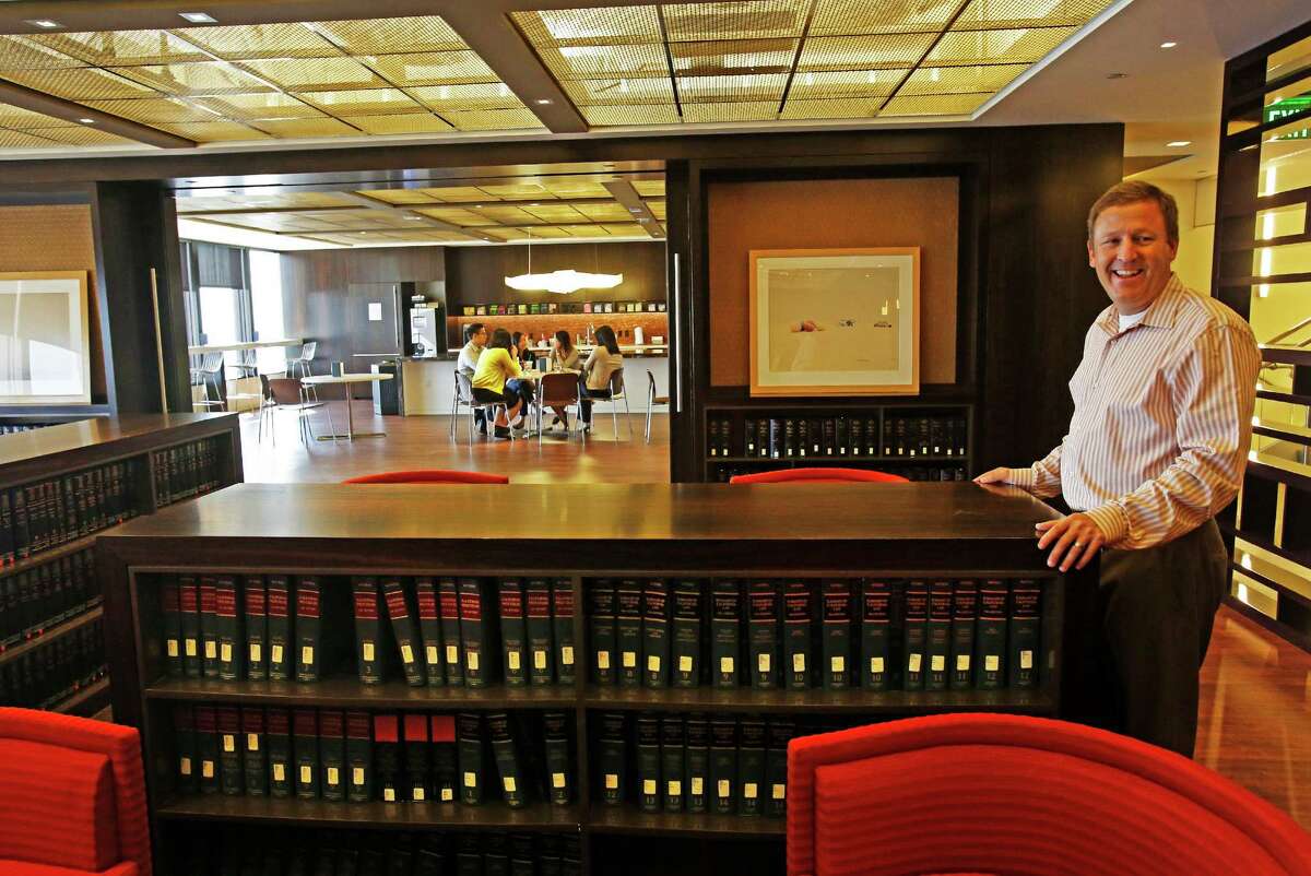Managing partner Greg Koltun, right, gives a tour of the "loungebrary" on Oct. 16, 2014 at the law firm Morrison & Foerster, which has scaled back its library to create a communal hang-out space called the "loungebrary" in Los Angeles. (Anne Cusack/Los Angeles Times)