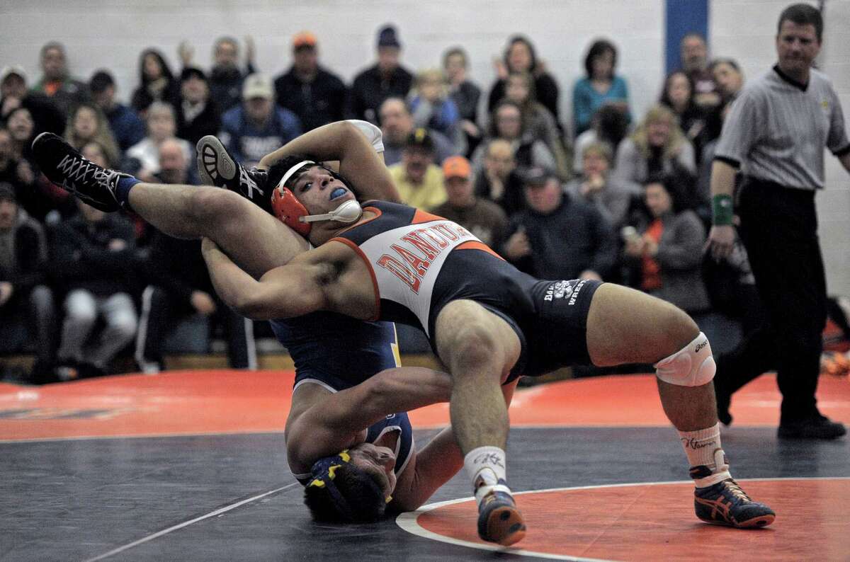 Newtown's Tom Long and Danbury's Johnny Garcia wrestle in the 195 pound weight class during a high school wrestling dual meet on Wednesday, January 28, 2015, at Danbury High School, Danbury, Conn.