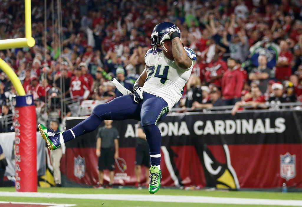 Seattle Seahawks running back Marshawn Lynch (24) dons his gloves during an  injury time out during the NFL Championship Game against the San Francisco  49ers at CenturyLink Field in Seattle, Washington on