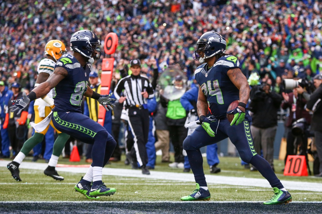 Seattle Seahawks running back Marshawn Lynch (24) dons his gloves during an  injury time out during the NFL Championship Game against the San Francisco  49ers at CenturyLink Field in Seattle, Washington on