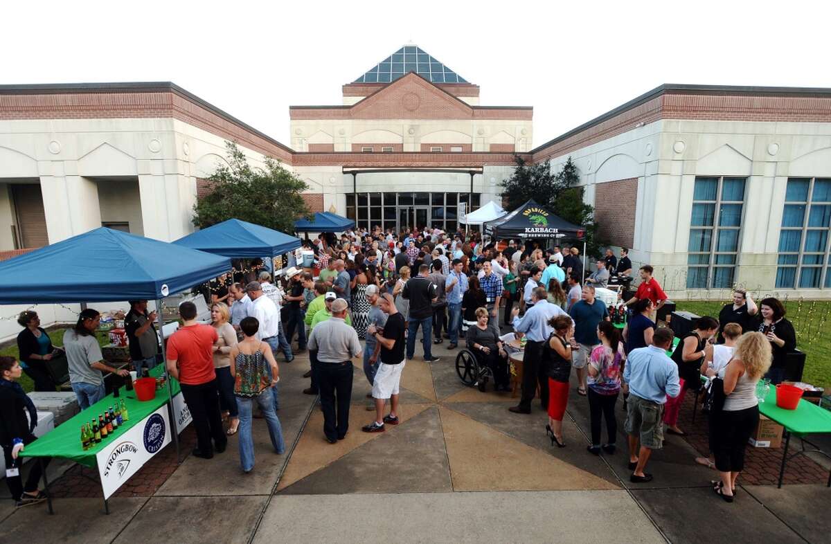 The courtyard of the Art Museum of Southeast Texas is packed during Friday's Art of Beer event. The Art Museum of Southeast Texas hosted the eighth annual The Art of Beer fundraiser on Friday night. Guests were invited to sample more than 100 beers and talk with brewers, as well as take in the exhibits at the museum. Funds from the event will go toward next exhibits and educational programs at the museum. Photo taken Friday 10/10/14 Jake Daniels/@JakeD_in_SETX
