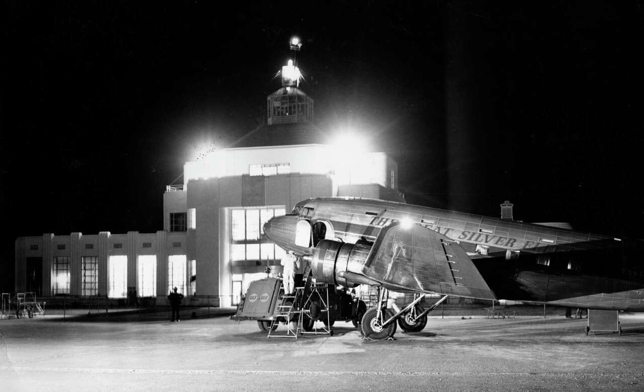 Mail and fuel go into a big 21-passenger Douglas in preparation for a night flight from Houston to New York. The administration building (Houston Municipal Airport) is in the background. Published Oct. 26, 1941 Eddie Schisser Chronicle file