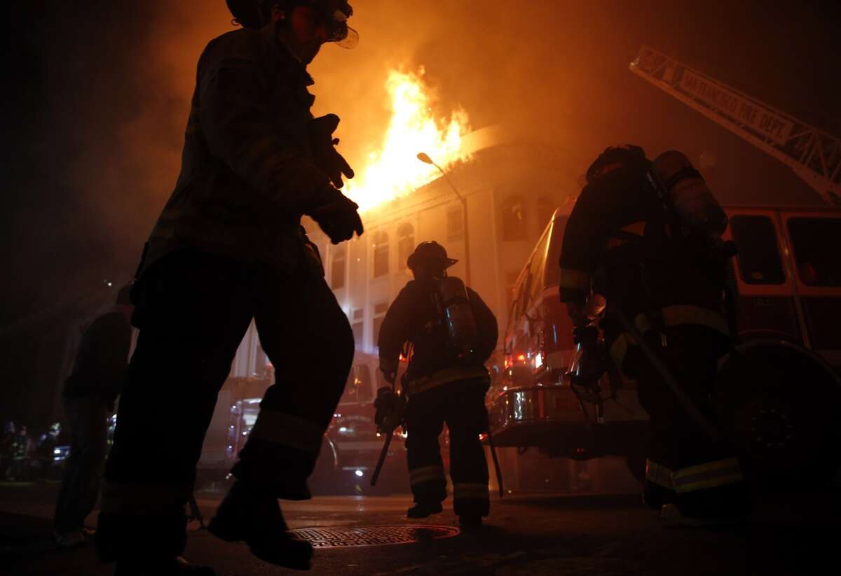 San Francisco Fire Department members fight blaze at 22nd and Mission Street in San Francisco, Calif., on Wednesday, January 28, 2015.