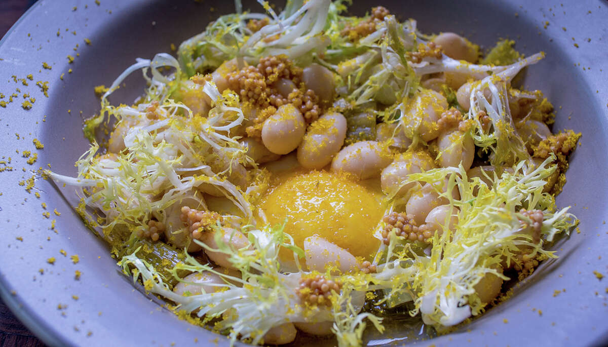 Butter beans and leeks augmented with fried egg, the crunch of frisee and the umami of bottarga ($15) at Huxley in the Tenderloin area of San Francisco.