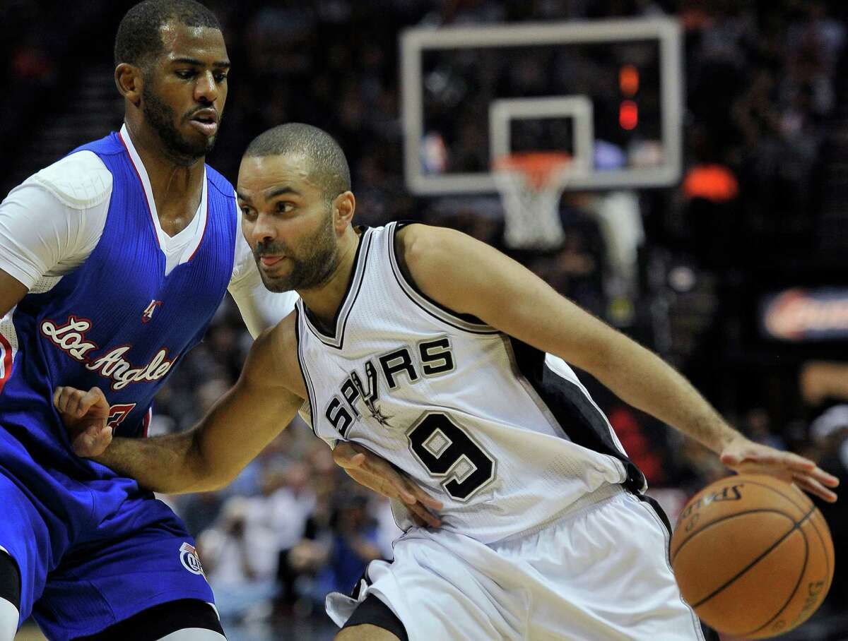 Spurs guard Tony Parker drives around the Los Angeles Clippers’ Chris Paul, during the first half on Dec. 22, 2014, in San Antonio.