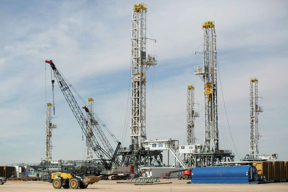 This photo shows a number of oil drilling rigs stacking in Helmerich & Payne International Drilling Company's yard in Ector County, Texas, Monday, Jan. 26, 2015. (AP Photo/Odessa American, Courtney Sacco)