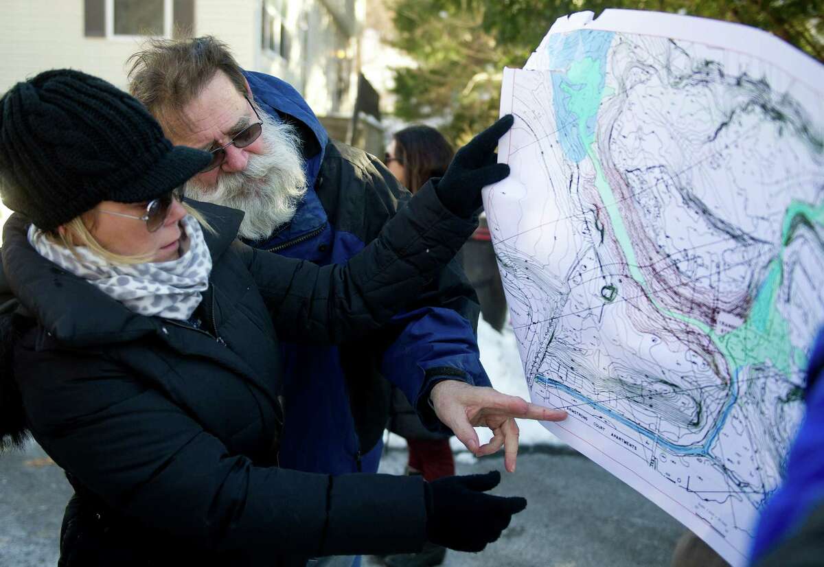 Dawn Fortunato and Otto Lauersdorf point to areas on a map during a meeting about contamination concerns at Booth Court in Greenwich, Conn., on Saturday, January 31, 2015.