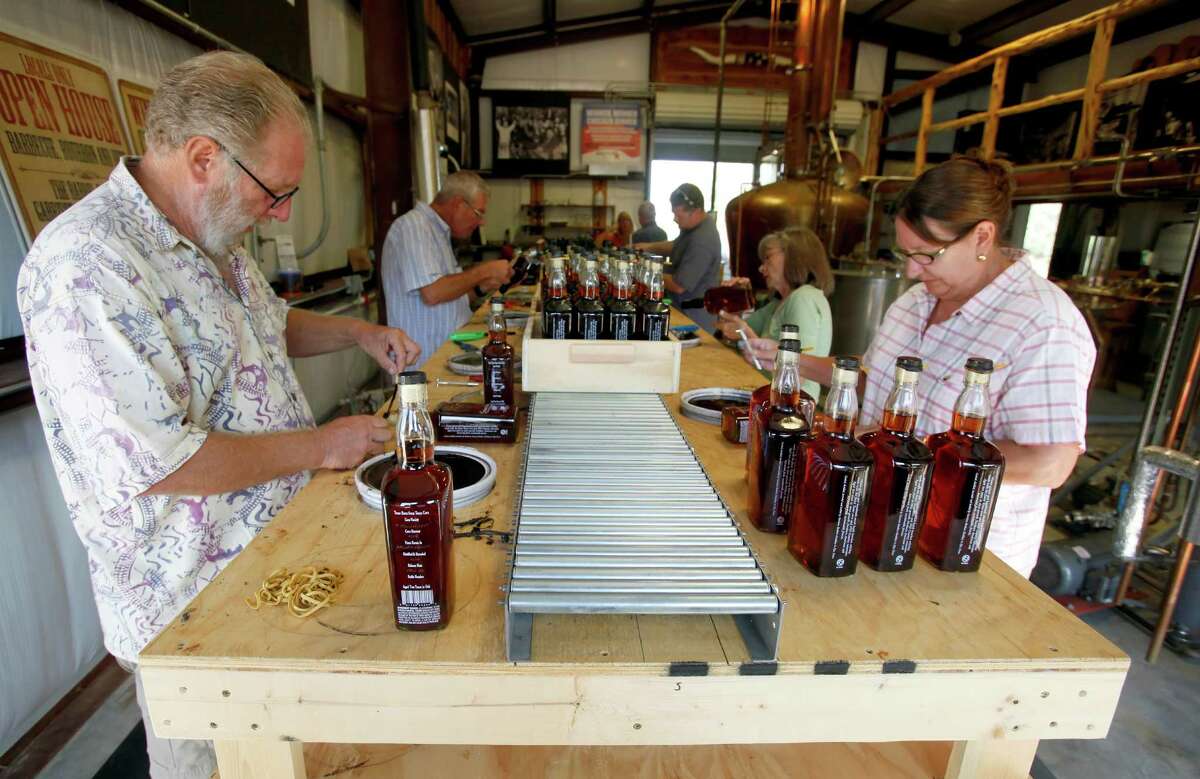Randy, left, and Debbie Garst of Dripping Springs help bottle at Garrison Brothers in Hye.