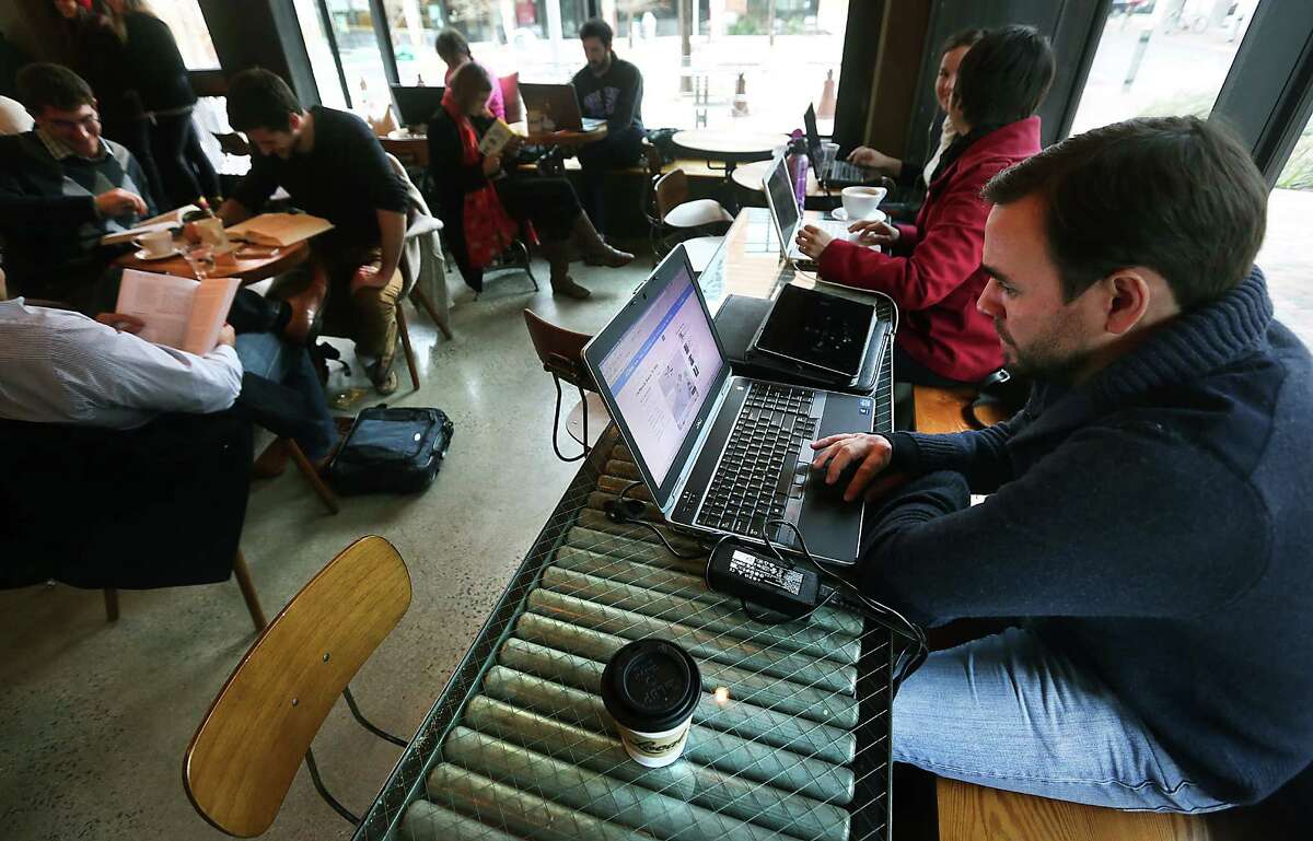 Brian Bridger, right works on his laptop at Local Coffee at The Pearl