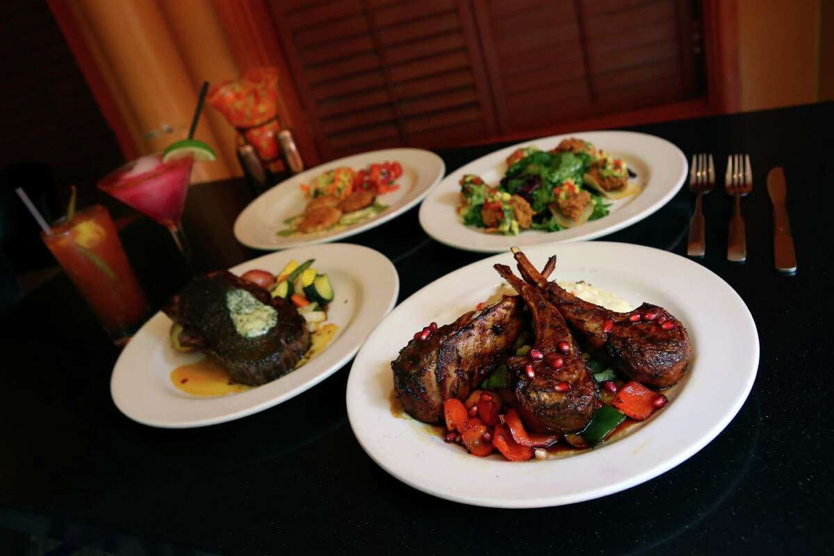 The achiote spiced double rib lamb chops, front, with the pink prickly pear margarita in the back.