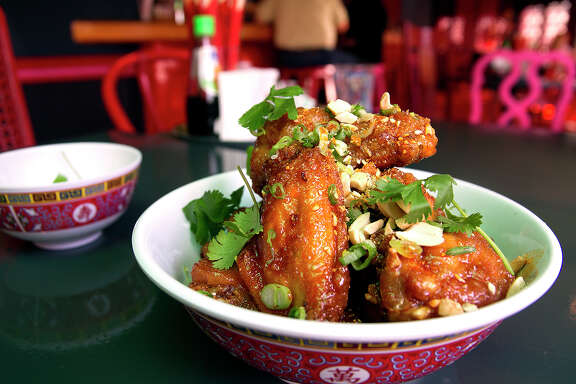 Twice fried chicken wings, topped with crab fat caramel, peanuts and cilantro