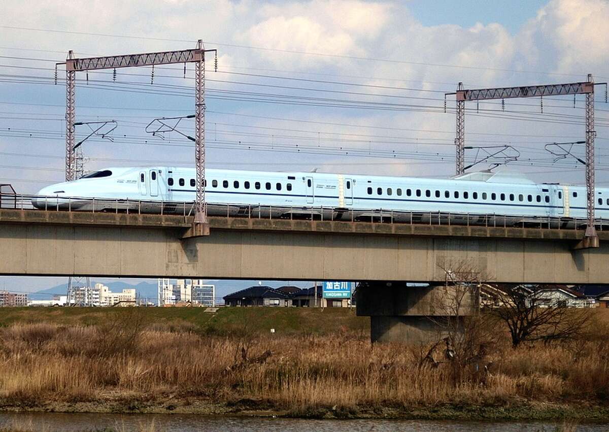 High-speed rail (such as Japan's Shinkansen bullet train, shown here) requires right-of-ways 50 to 80 feet wide, and in urban areas, a platform 20 feet tall. That's fine along a freeway. But it would devastate neighborhoods. (Photo: OpenCage.info, edited by Lisa Gray. CC BY-SA license.)
