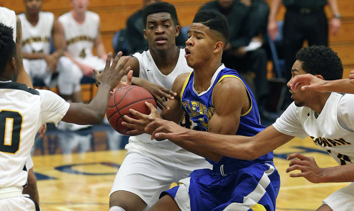 Clemens’ Frank Harris finds it tough maneuvering in the middle against Brennan at Taylor Field House on Dec. 20, 2014.