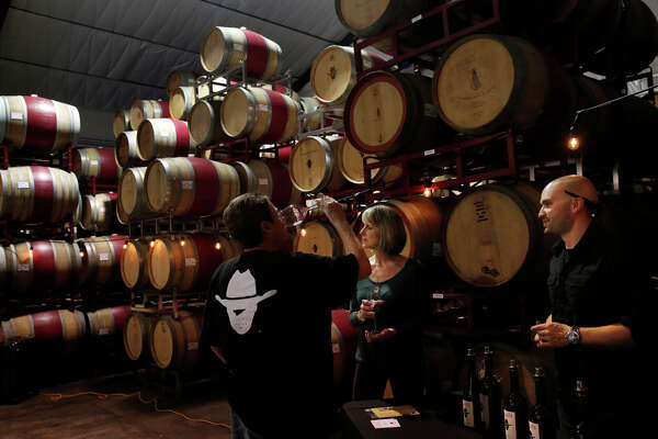 Debbie Stack (left) and Becky White taste wine with owner Isy Borjón at Borjón Winery.