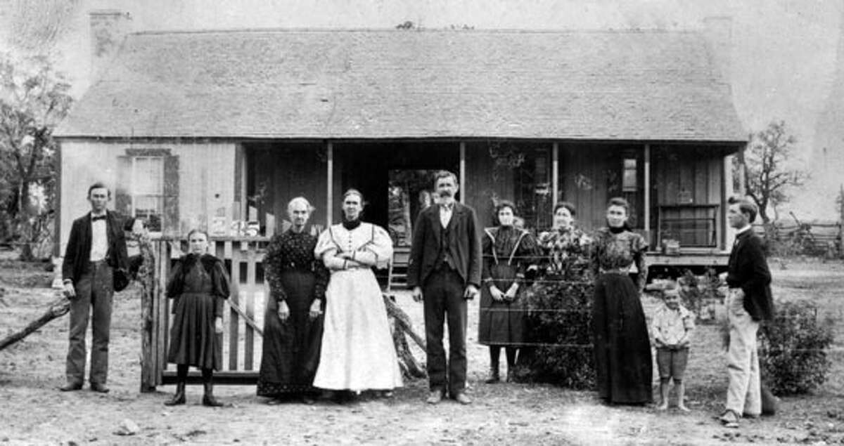 The Johnson family stands in front Lyndon B. Johnson's birthplace 1897.