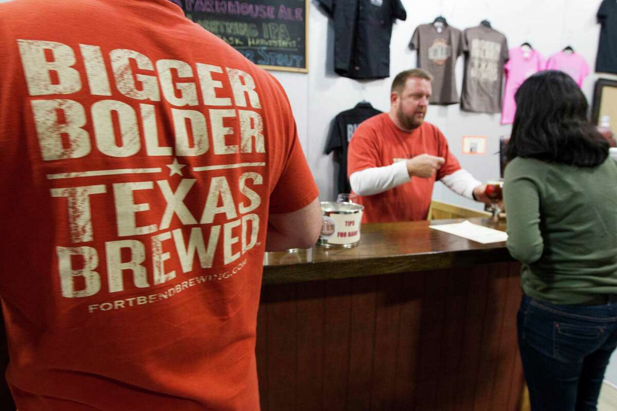 A beer lovers enjoys cold ones during the 1st anniversary party of the Fort Bend Brewing Co. on Thursday, Nov. 14, 2013, in Sugar Lane. ( J. Patric Schneider / For the Chronicle )