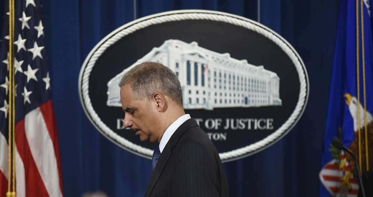 Attorney General Eric Holder steps away from the podium at a news conference at the Department of Justice on Tuesday, Feb. 3, 2015 in Washington. Standard & Poor's is paying about $1.38 billion to settle government allegations that it knowingly inflated its ratings of risky mortgage investments that helped trigger the financial crisis, the Justice Department announced Tuesday. (AP Photo/Kevin Wolf)