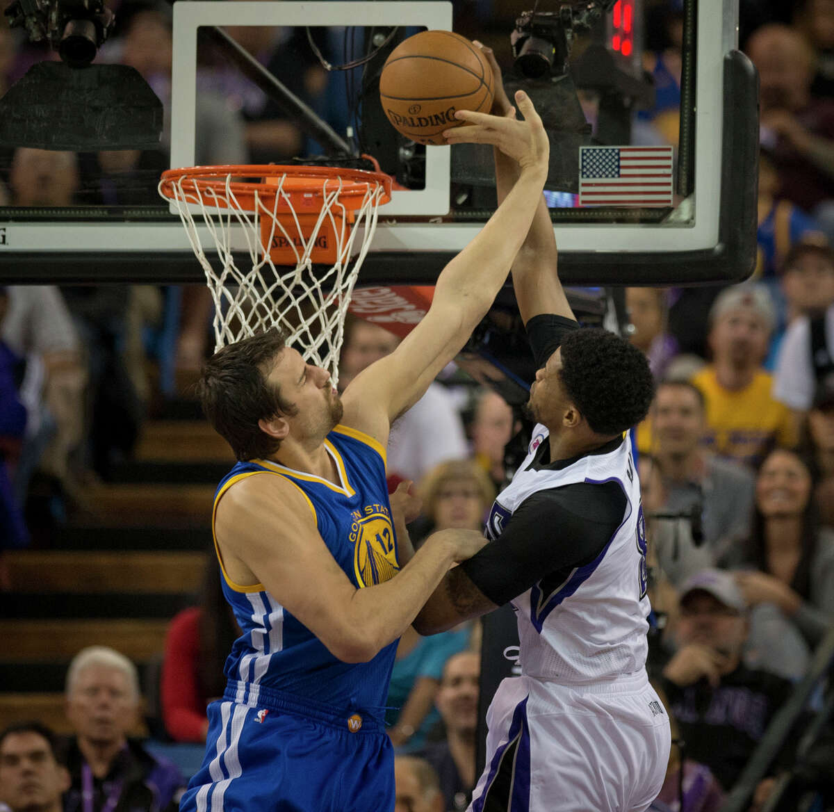 Andrew Bogut rises to the challenge as the Kings’ Rudy Gay attempts a first-quarter dunk.