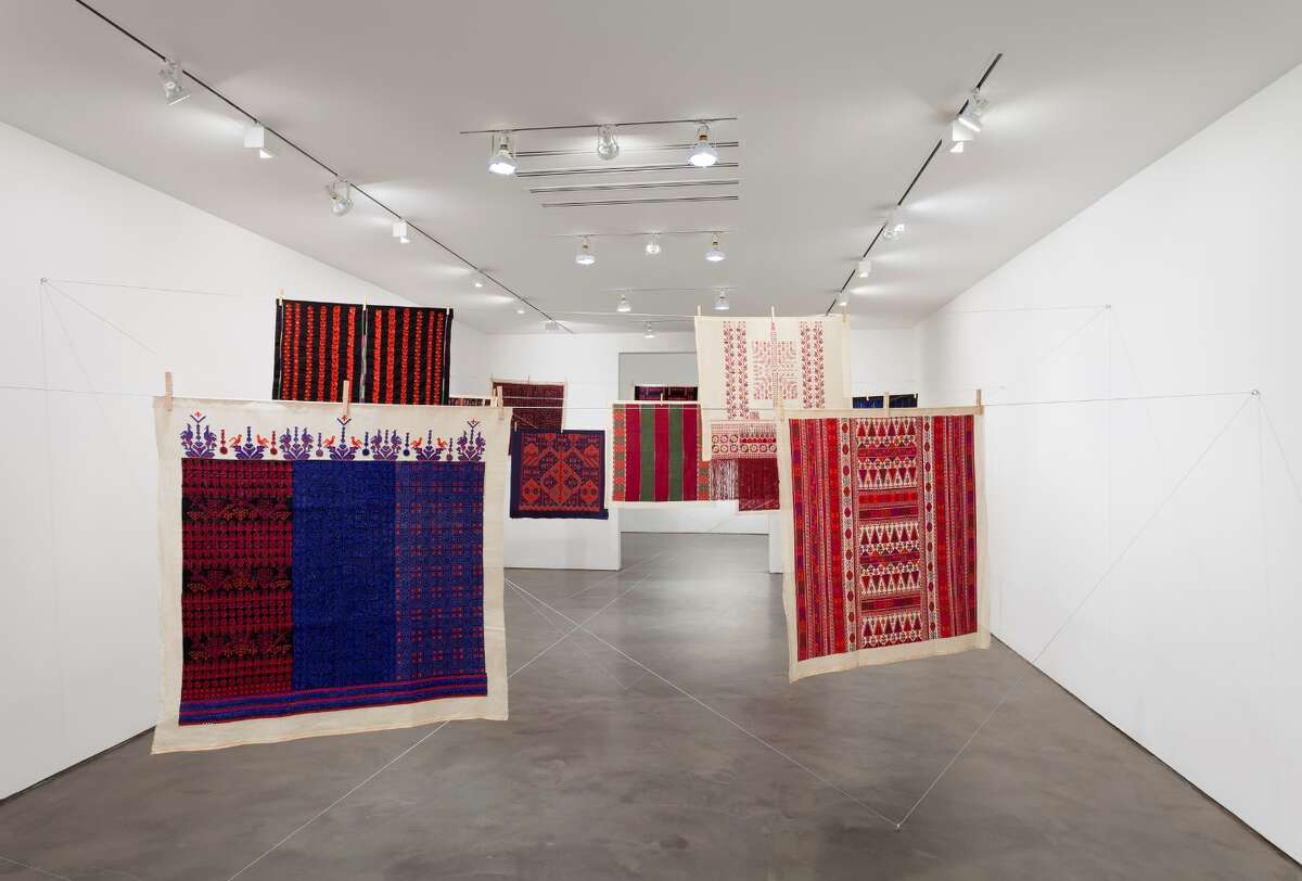 "Twelve Windows," an installation by Mona Hatoum with Inaash, is on view through Feb. 8 at the Museum of Fine Arts, Houston. 9 2012-2013, 12 pieces of Palestinian embroidery on fabric, wooden clothes pegs, steel cable, each embroidery: 39 3/8 x 39 3/8 inches (100 x 100 cm.) Installation view at Alexander and Bonin Gallery, New York, Â Mona Hatoum, 2014; photograph Â Joerg Lohse. 2012-2013, 12 pieces of Palestinian embroidery on fabric, wooden clothes pegs, steel cable, each embroidery: 39 3/8 x 39 3/8 inches (100 x 100 cm.) Installation view at Alexander and Bonin Gallery, New York, Â Mona Hatoum, 2014; photograph Â Joerg Lohse.)