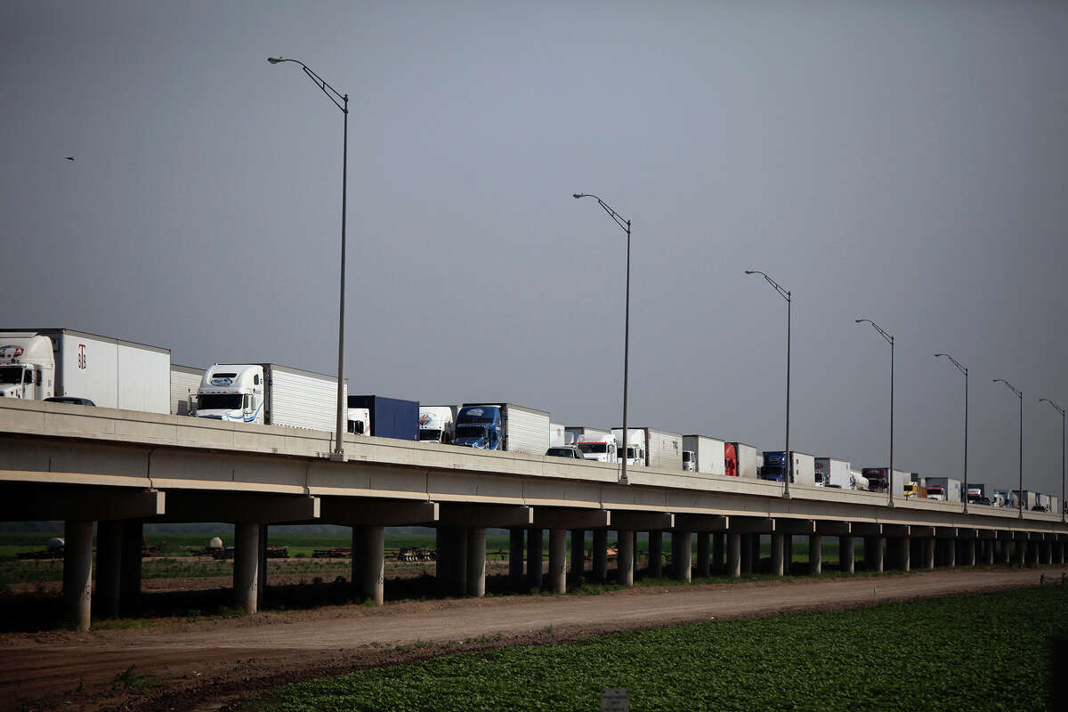 Trucks wait on the Pharr-Reynosa International Bridge to enter the United States and for their trucks and loads to be inspected by federal agriculture specialists.