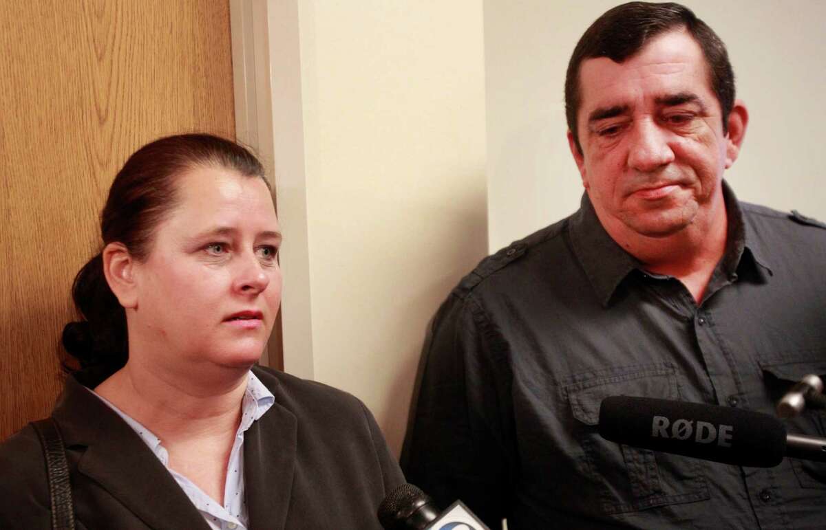 Colleen Middleton, left, and Bobby Middleton, center, parents of Robert Middleton speak to the media in the 359th State District Court Thursday, March 6, 2014 in Conroe after a ruling by Judge Kathleen Hamilton. The judge ruled that Donald Willburn Collins will be tried as an adult for allegedly setting, 8-year-old Robert Middleton, on fire with gasoline in 1998. Robert died in 2011. ( Melissa Phillip / Houston Chronicle )