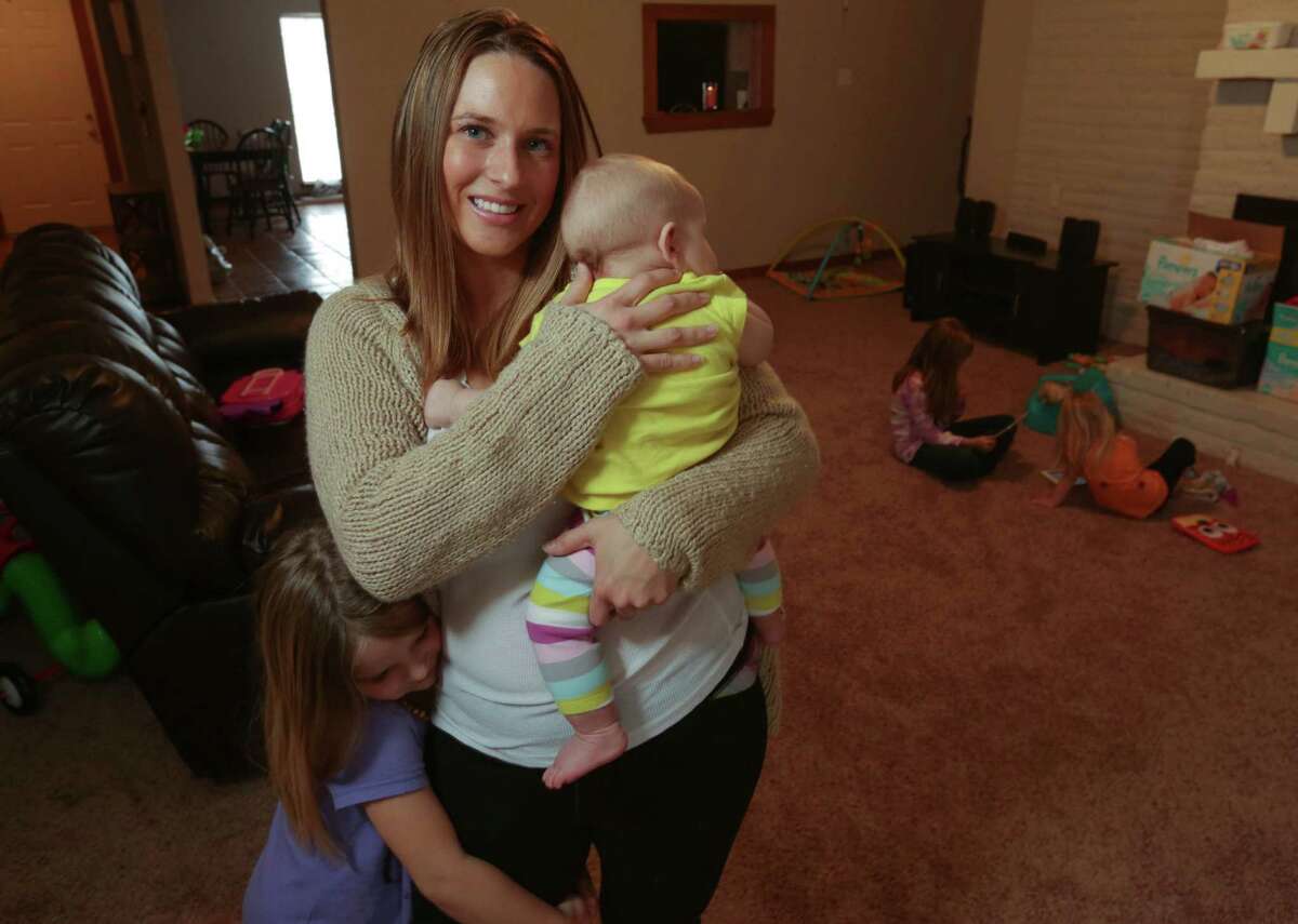Krystal Bettilyon, with her daughters in Deer Park, said after researching vaccines, she became uncomfortable. "It's a personal choice," she said.﻿﻿