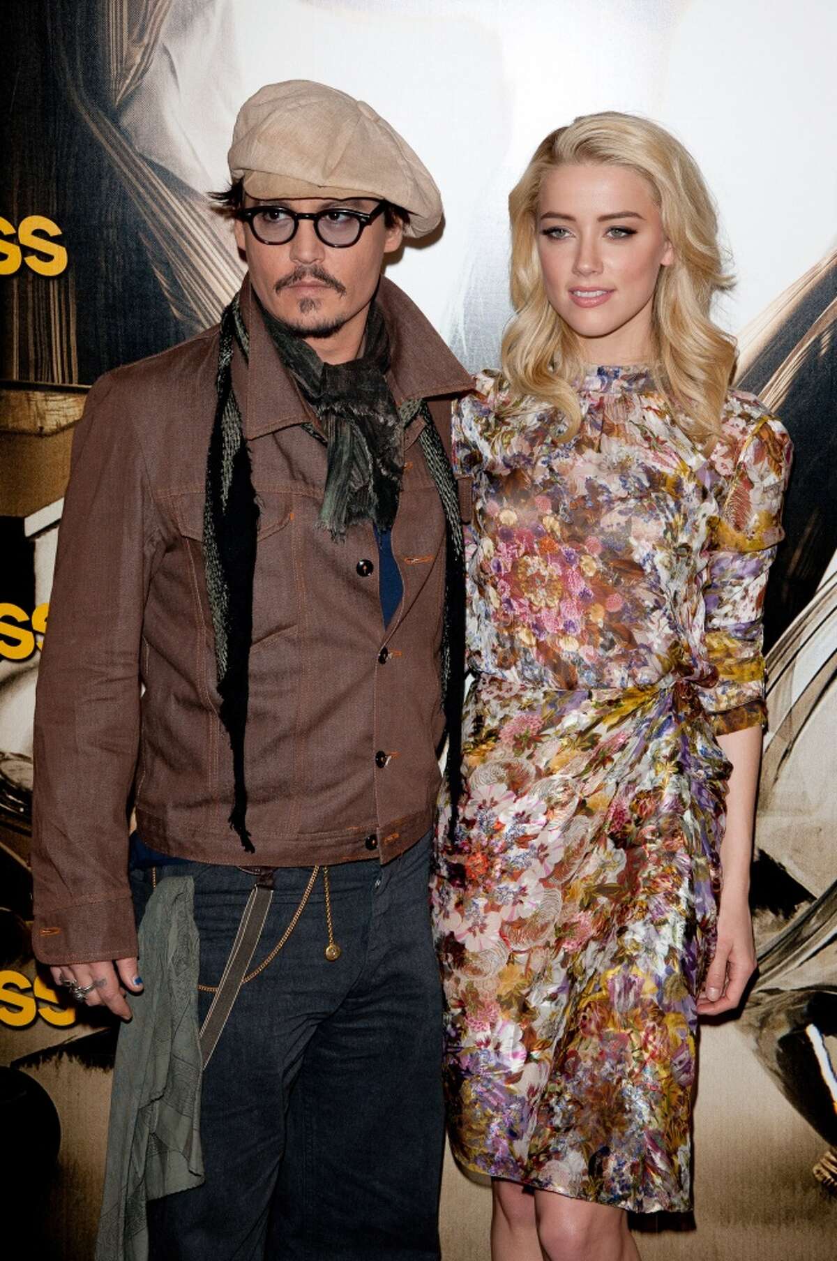 Johnny Depp and Amber Heard pose during the 'Rhum Express' Photocall at Hotel Paris Plaza Athenee on November 8, 2011 in Paris, France.