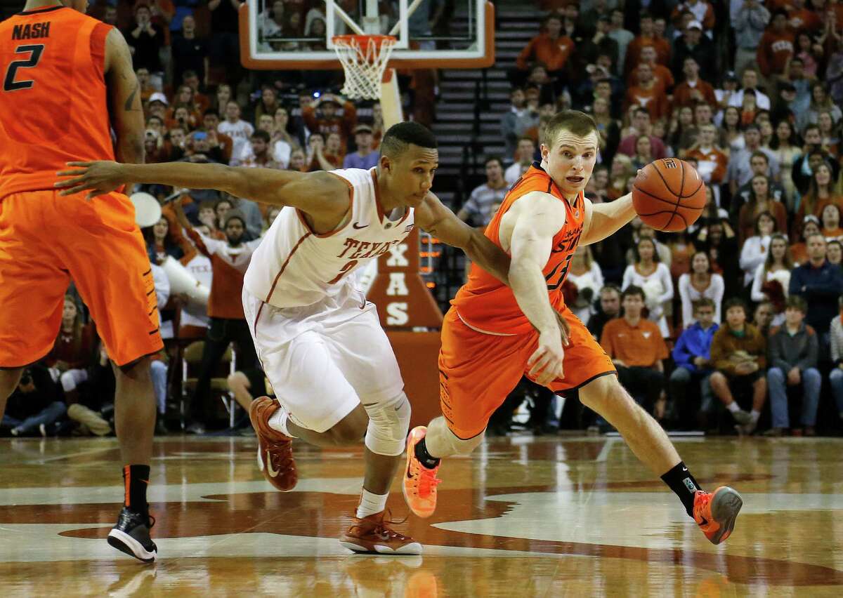 Phil Forte III (13) of Oklahoma State drives around Demarcus Holland (2).