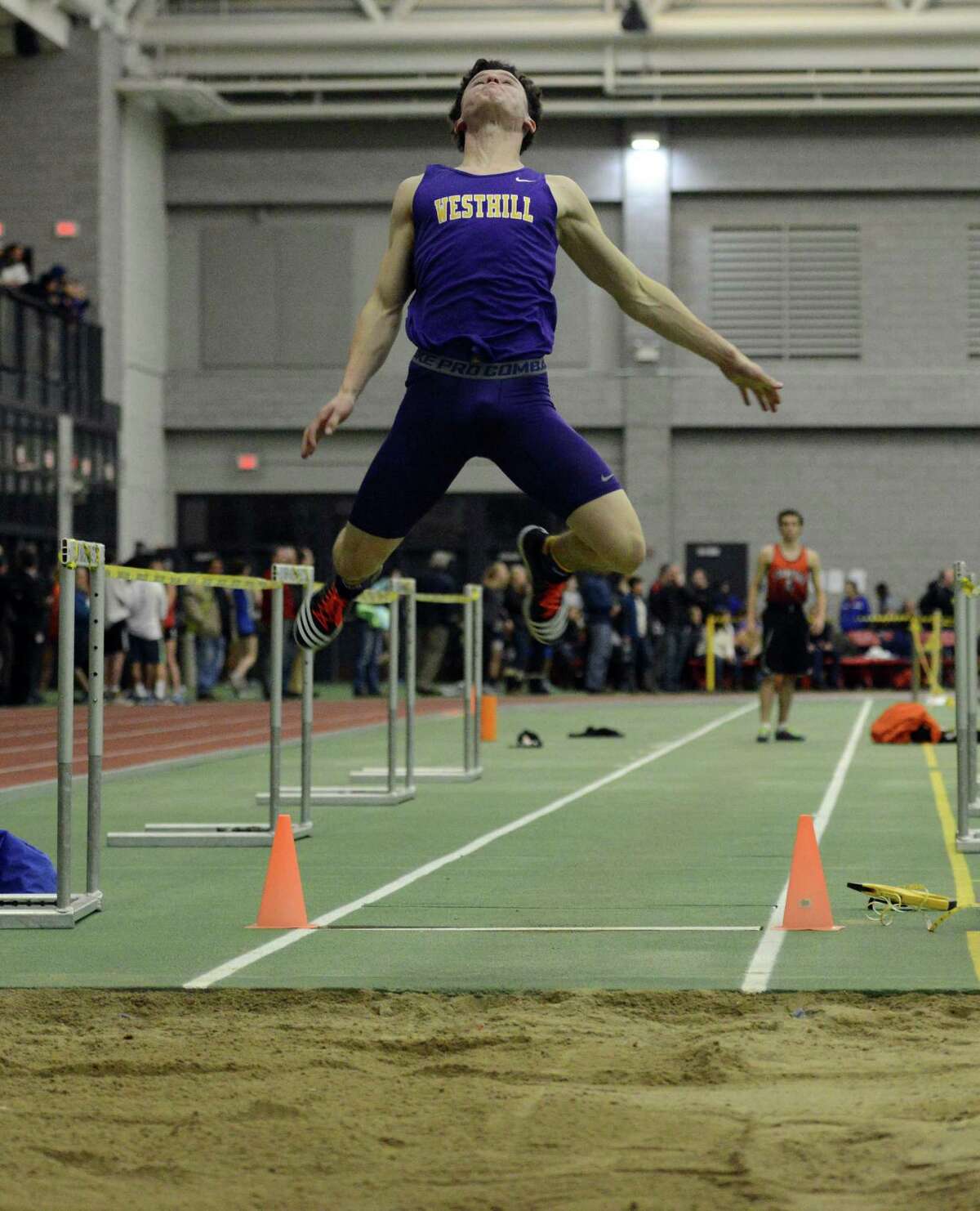 Westhill's Chris Rough competes in the long jump event Thursday, Feb. 5, 2015, during the FCIAC boys and girls indoor track and field championhsips at the Floyd Little Athletic Center in New Haven, Conn.