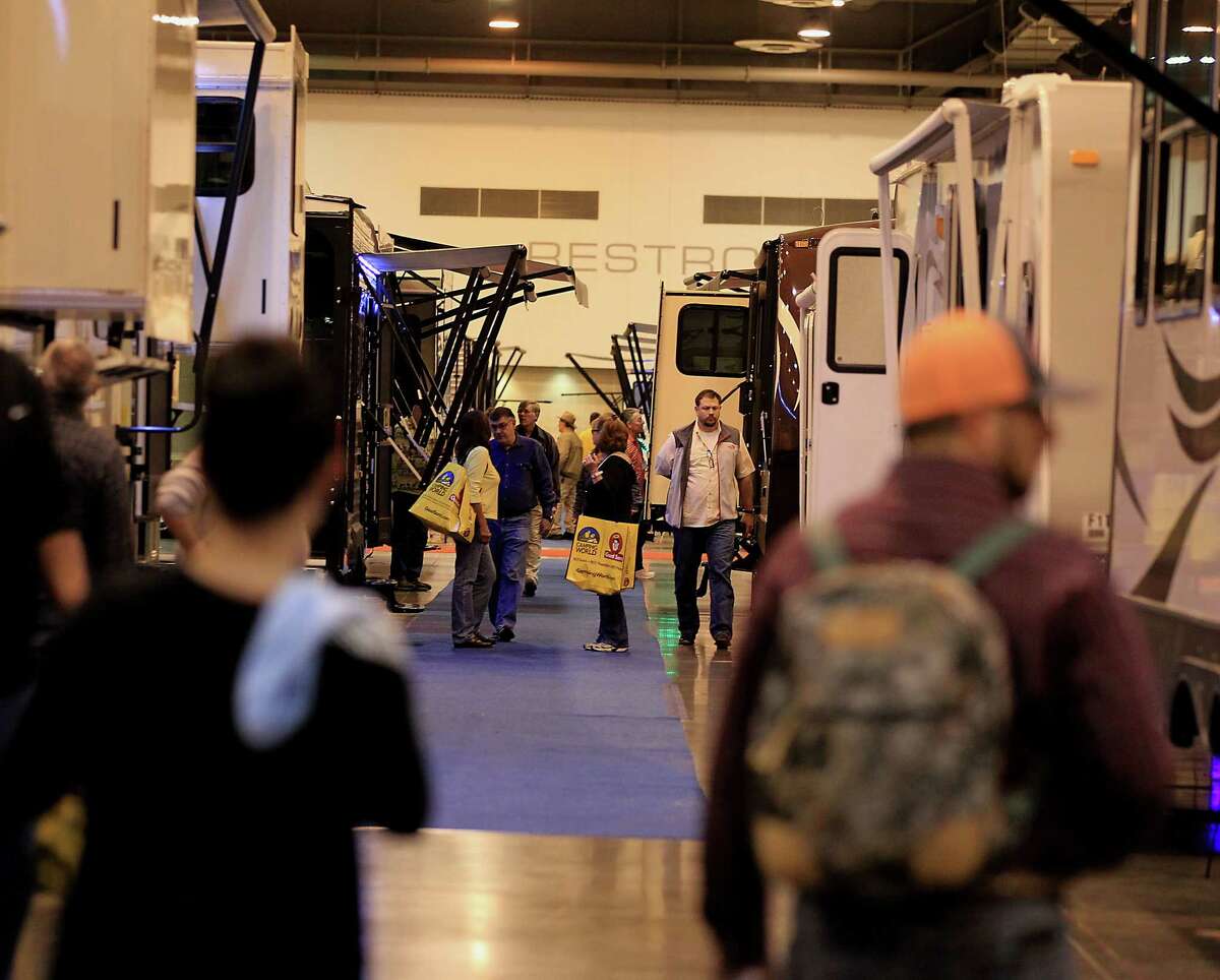 Attendees look over travel trailers on display during the 51st Annual Houston RV Show NRG Center Thursday, Feb. 5, 2015, in Houston. ( James Nielsen / Houston Chronicle )