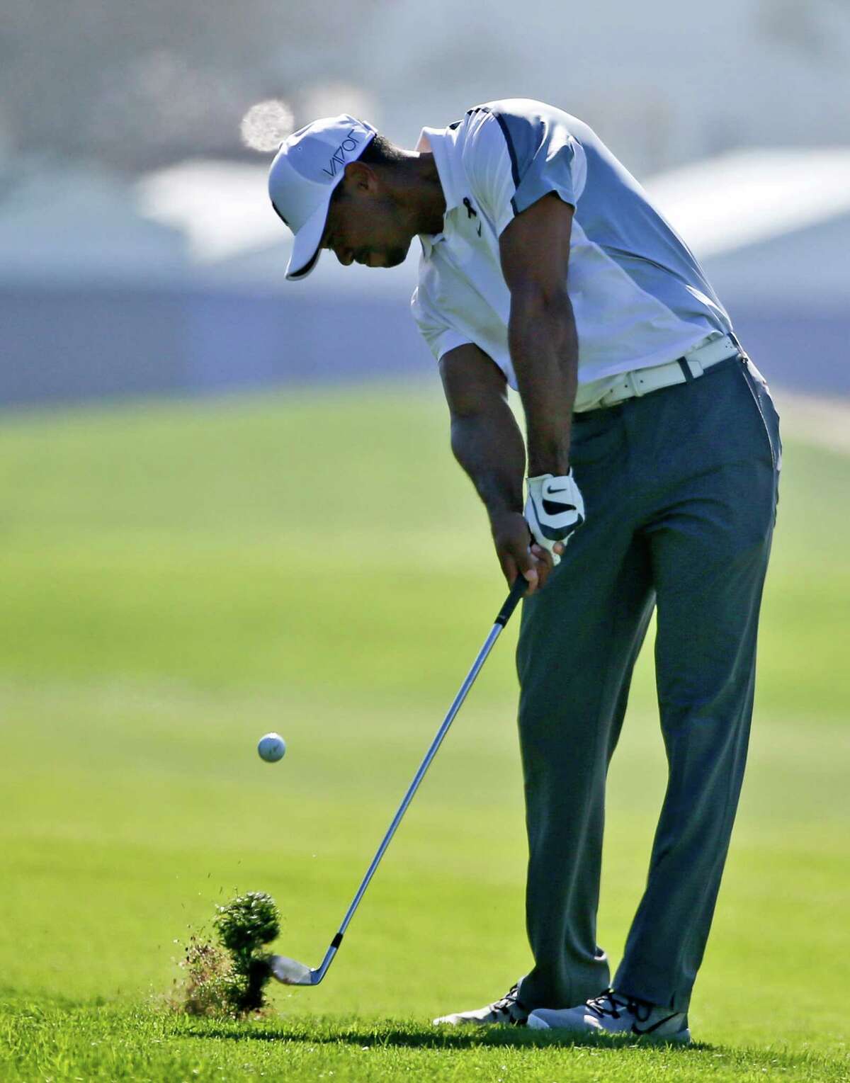 Tiger Woods hits his approach shot to the 10th hole (his first) on the north course at Torrey Pines during the first round of the Farmers Insurance Open golf tournament Thursday, Feb. 5, 2015, in San Diego. Woods missed the green with the short shot and made bogie. (AP Photo/Lenny Ignelzi) ORG XMIT: CALI105