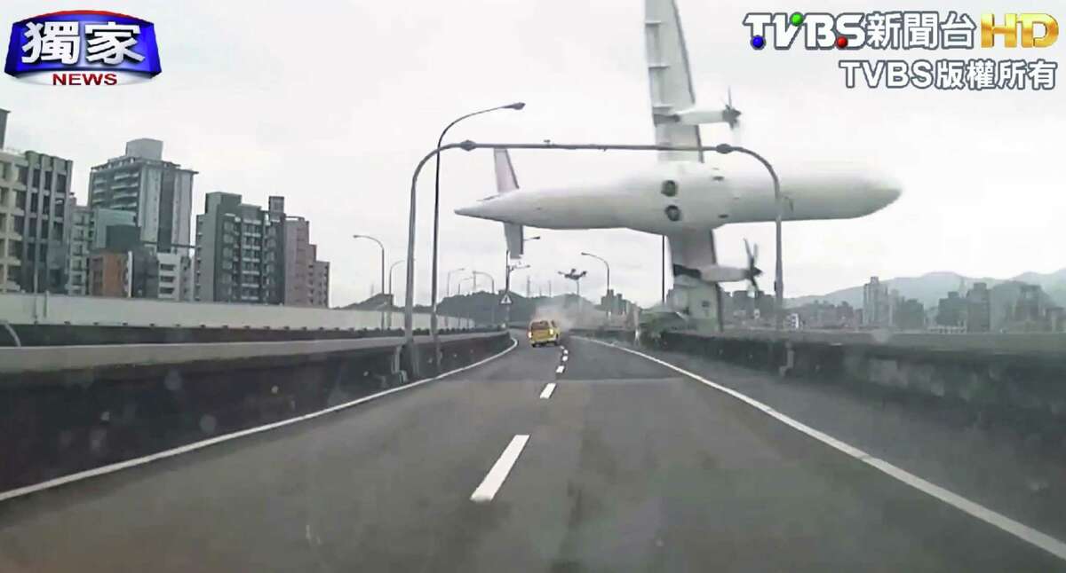 A jet clips an elevated road before crashing on Wednesday in Taiwan.