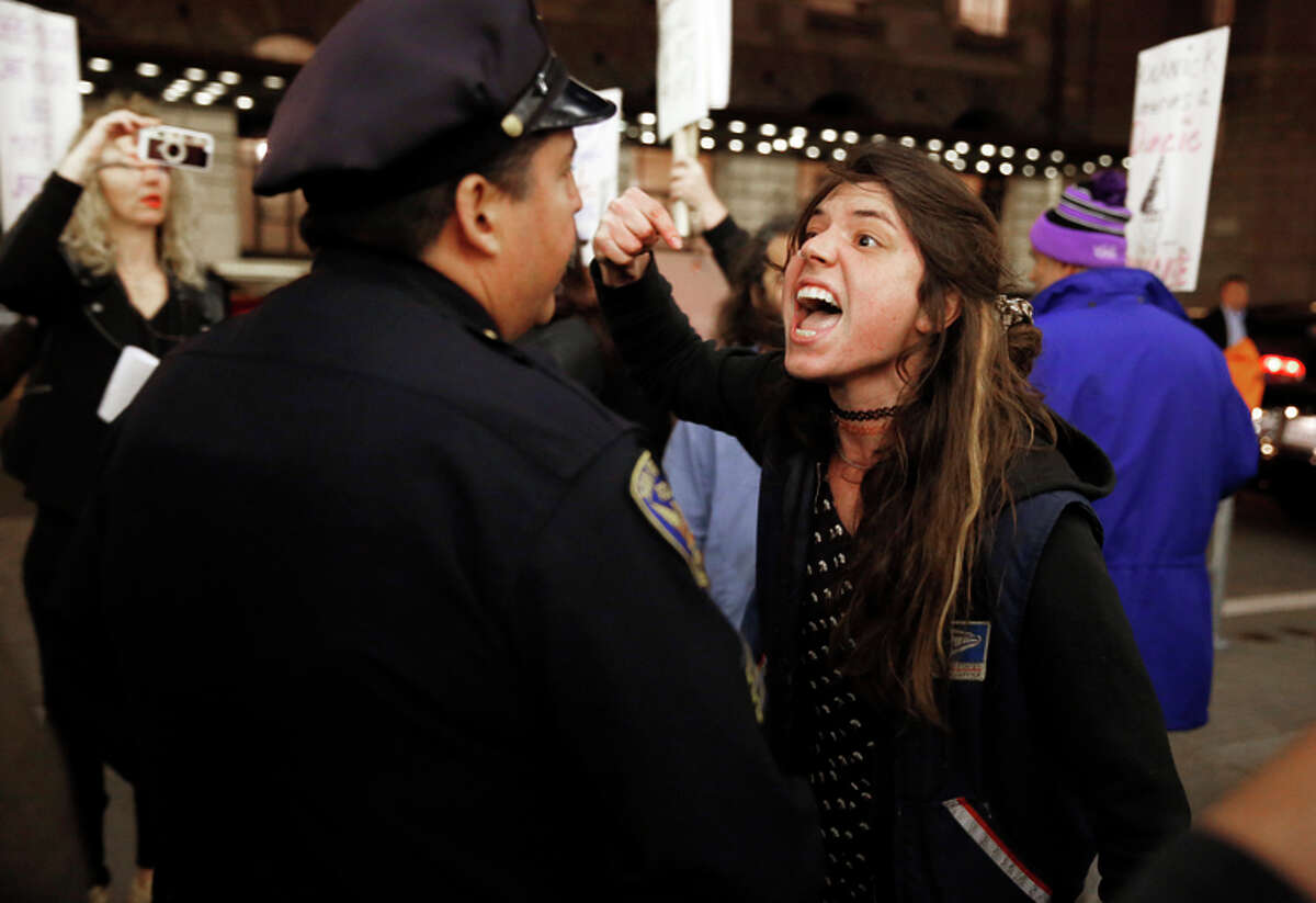 Protester Lena Seagrabe yells at San Francisco police Officer Jesus Pena outside the Crunchies.