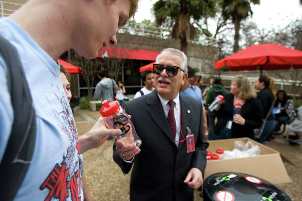 University of Houston student Houston Boyer, of Dickinson, receives a water bottle from Carl Carlucci during a rally to kick off UH's RecycleMania event on campus Wednesday, Jan. 20, 2010, Houston. RecycleMania is a friendly competition between colleges and universities nationwide which encourages green initiatives through measured recycling and events which promote sustainability. The contest runs through March 27. ( Brett Coomer / Chronicle )