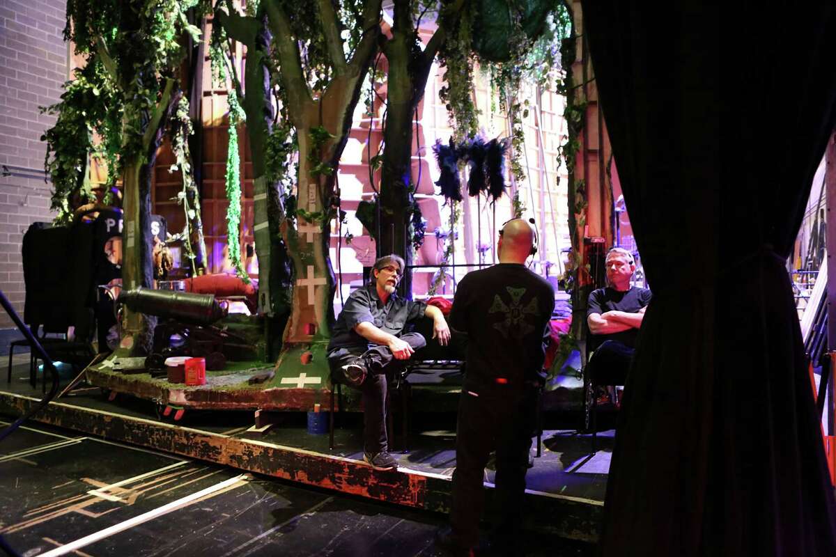 Bob Baker and Ralph Evans sit on the 40-by-60-foot wagon that moves the set for "The Magic Flute" on and offstage. After the set is loaded onto the wagon, a different set - for "Madame Butterfly" - will take its place on the Brown Theater stage.
