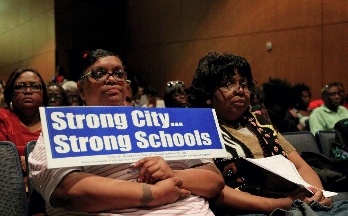 Gloria Simmons, who works for the La Marque school district, shows her support Sunday during a Town Hall meeting about the Texas Education Agency's decision to revoke the district's accreditation.