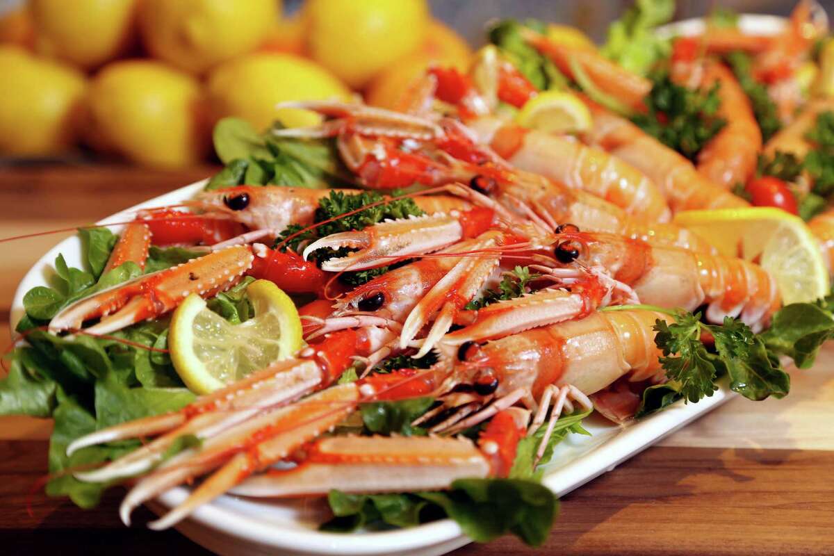 Sicilian lobster scampi, marinated with sea salt, olive oil, chives, citrus pink pepper and candid tomatoes at Amalfi 
