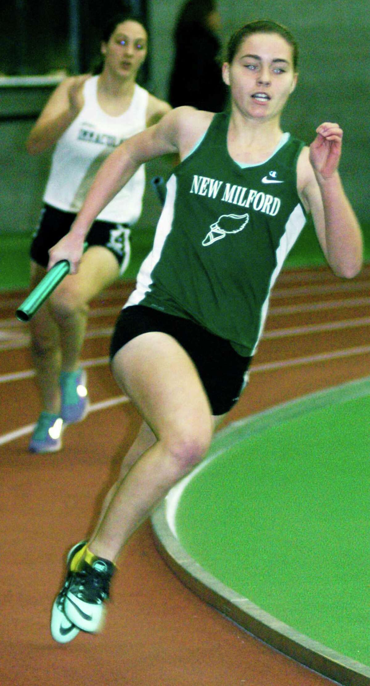 Raquel Morehouse of the Green Wave turns the corner for home during her leg of the girls' 4 x 200-meter relay at the South-West Conference indoor track and field championship meet at Hillhouse High School in New Haven. Feb. 7, 2015