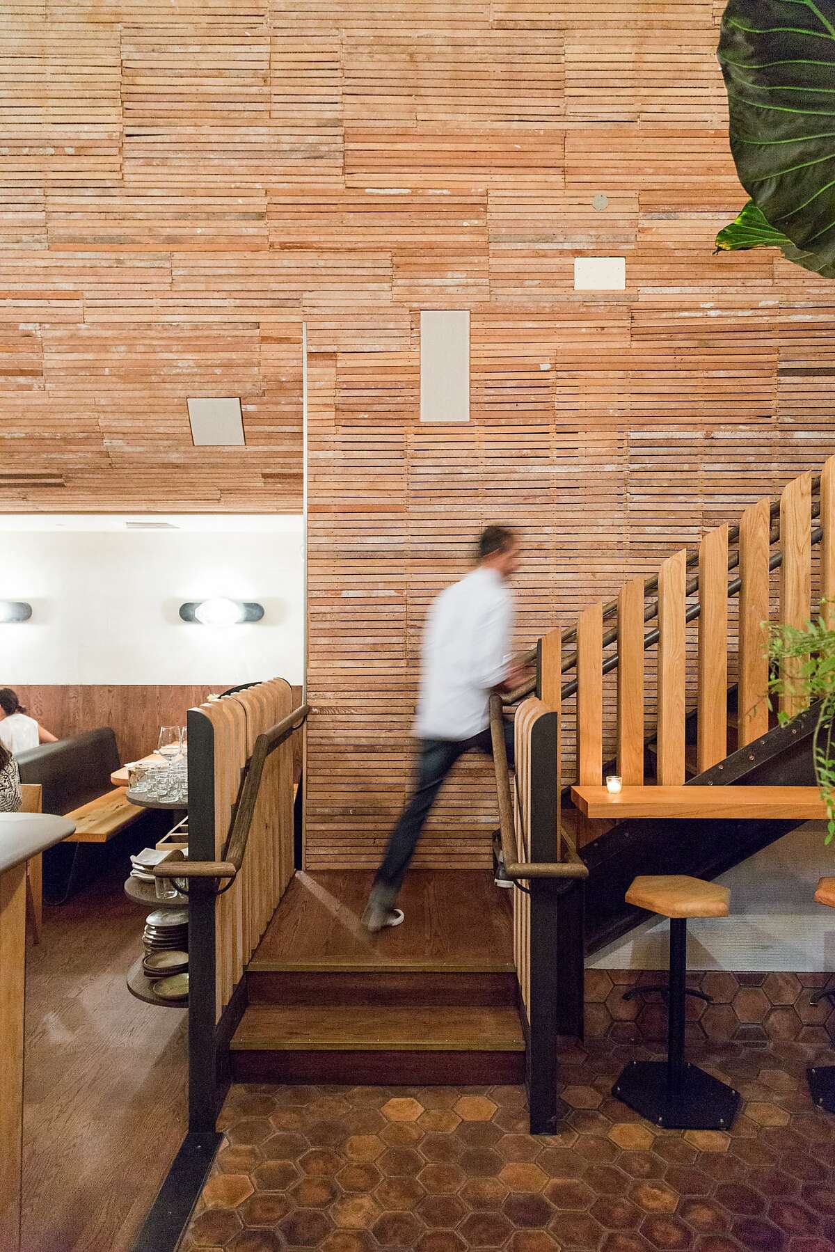 The original plaster was removed from the wood-slat walls exposing the architecture of the building at The Progress restaurant in San Francisco, Calif., Wednesday, February 4, 2015.