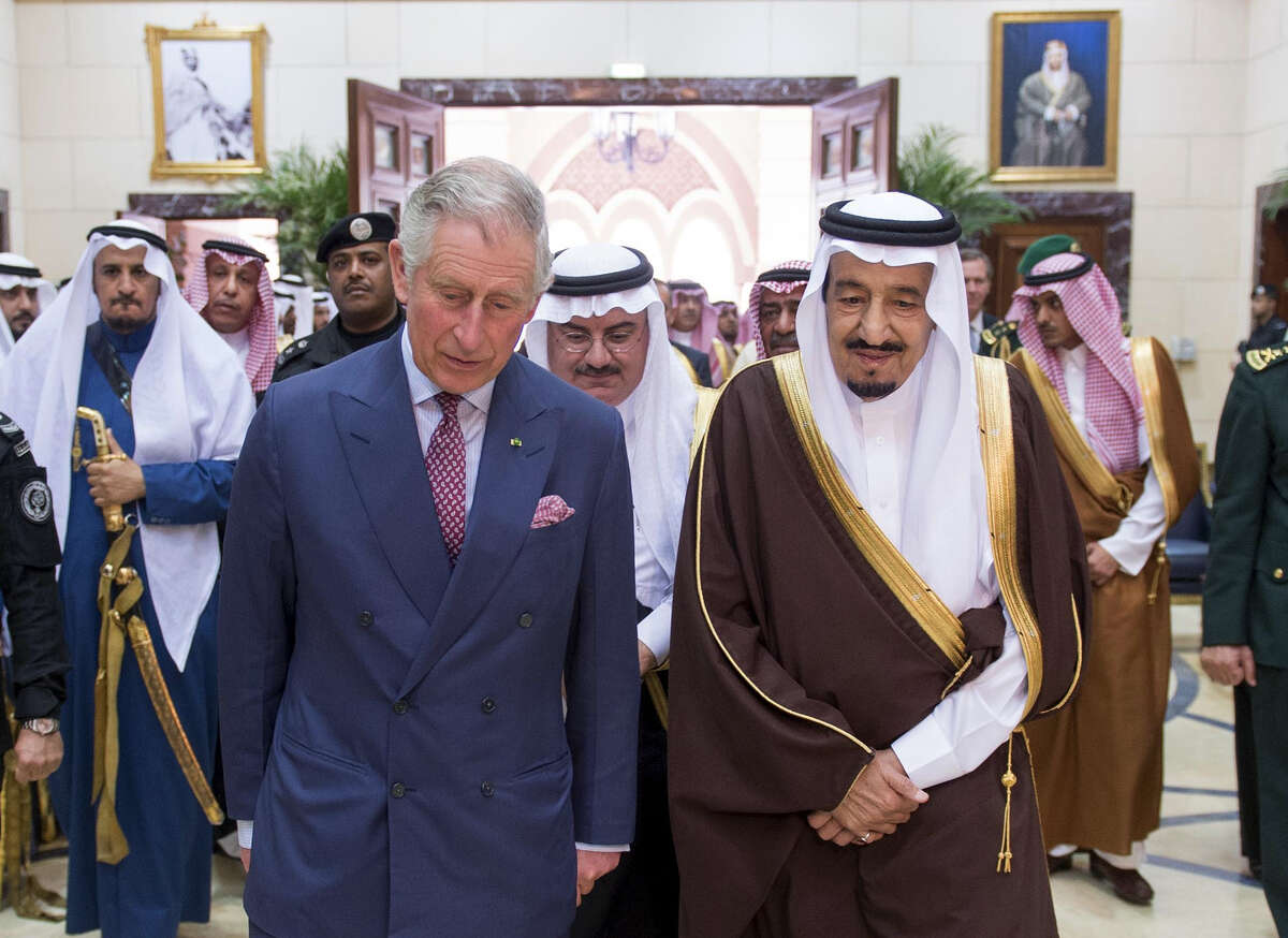 In this photo provided by the Saudi Press Agency, Britain's Prince Charles, center left, walks with Saudi King Salman at Al Ergah Palace, Riyadh, Saudi Arabia, Tuesday, Feb. 10, 2015. (AP Photo/SPA)