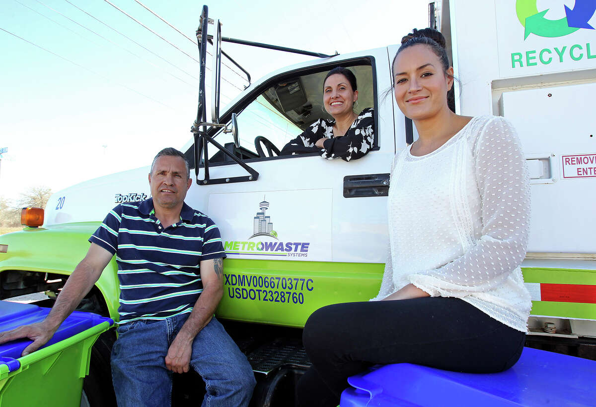 Metro Waste Systems founders Hector (from left), Rachel and Deborah Reyna on Tuesday sit near — and in — one of three trucks used in their family-owned business operating out of offices on Texas 16 South in San Antonio.