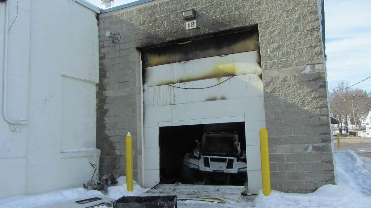 Truck badly damaged from fire can be seen inside a wash bay at Albany Truck Sales and Service at 90 Harts Lane, Menands, on Wednesday. (Bob Gardinier / Times Union)