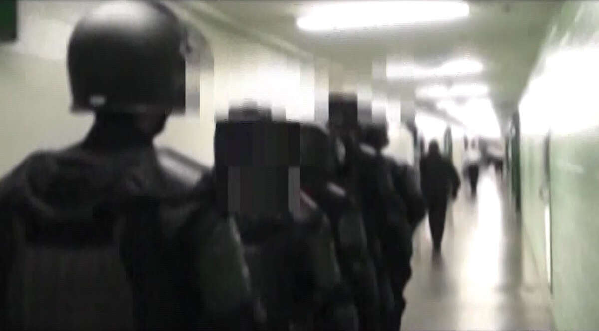 A Harris County grand jury has cleared eight sheriff employees of criminal wrongdoing for their roles in removing a jail inmate who later died in a hospital, Sheriff Adrian Garcia said. Garcia on Wednesday released a 30-minute videotape recording of sheriff's deputies' action, which are shown in these video frame grabs.
