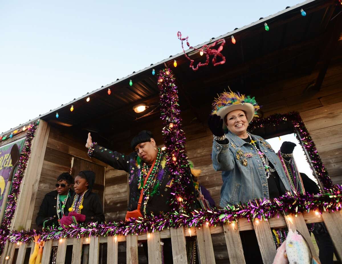 Float riders celebrate the beginning of Mardi Gras in Port Arthur on Thursday. Port Arthur held the Courir du Mardi Gras Parade along Lakeshore Drive on Thursday night. The small parade acts as one of the opening ceremonies of Mardi Gras in the city. Photo taken Thursday, 2/27/14 Jake Daniels/@JakeD_in_SETX