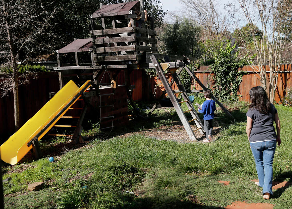 Julie Schiffman, who has endured criticism over her measles comments, watches her sons play at their Marin County home.