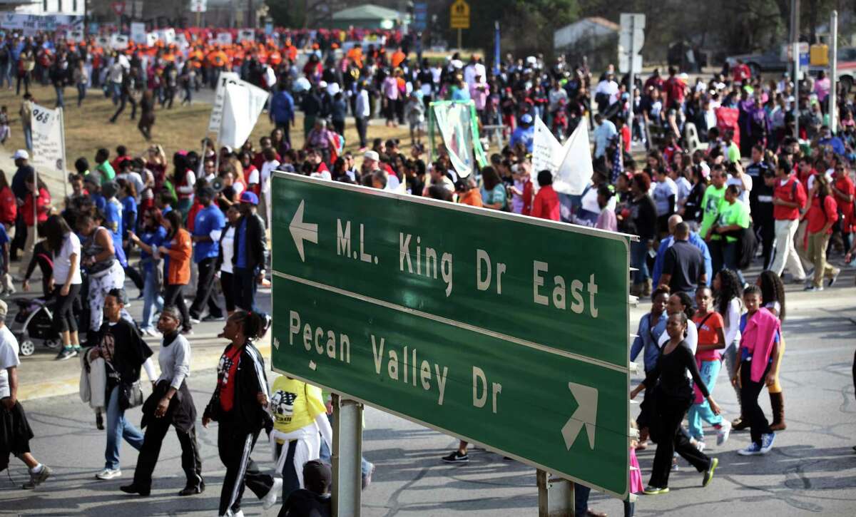 Walkers in the Martin Luther King, Jr. March follow MLK Blvd. in January 2013 where it turns and goes under I-10.